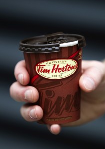 A cup of Tim Hortons Inc. coffee is displayed for a photograph in Toronto, Ontario, Canada, on Wednesday, Aug. 3, 2011. Tim Hortons Inc. is a chain of franchise fast food restaurants that serve coffee drinks, tea, soups, sandwiches, donuts, bagels, and pastries. Photographer: Brent Lewin/Bloomberg via Getty Images